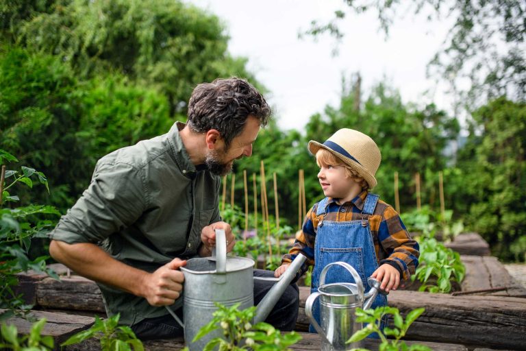 small-boy-with-father-gardening-on-farm-growing-o-2022-02-02-03-56-30-utc